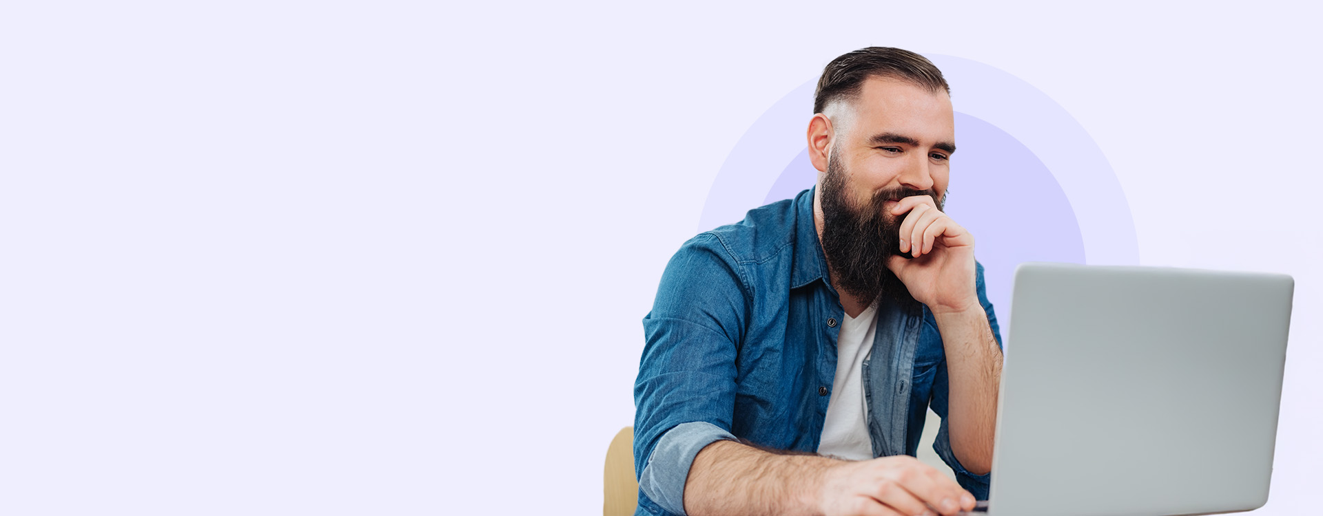 A cheerful professional man working on a laptop, symbolizing VanderHouwen's dedication to helping individuals find their dream jobs in Technology, Engineering, Accounting and Finance, and Human Resources.