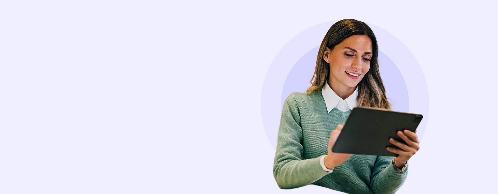 A smiling professional woman using a tablet, representing VanderHouwen's 2025 Salary Guides with essential salary data and insights for hiring and motivating employees in a dynamic job market.